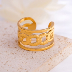 Minimalist gold plated stainless steel chain link open ring on a textured stone