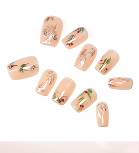 Detail of square press-on nails featuring golden butterflies and red cherry leaf art
