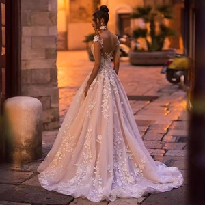 Elegant off-shoulder lace wedding gown with floral appliques and sheer back design