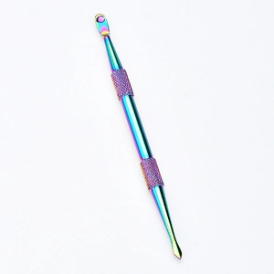 Macro view of a colorful rainbow stainless steel dual-head nail tool with knurled grip
