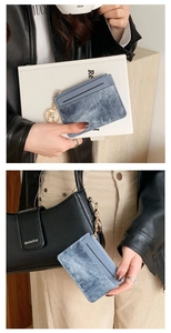 Blue denim texture slim card holder with gold zipper and keychain in daily use scenario