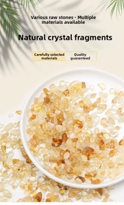 Polished natural citrine crystals in a white ceramic dish with leaf shadows