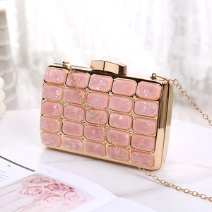 Detailed view of a pink marble acrylic clutch bag with gold metal frame and chain