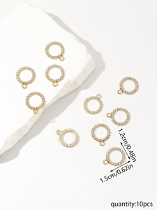 Close-up of golden geometric sun pendants with rhinestones and precise size markings