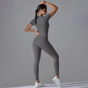 Close-up of seamless dark grey zip-up yoga jumpsuit with short sleeves and slim fit design
