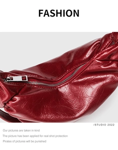 Detailed macro view of red pleated leather texture with silver metal zipper fastener