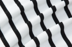 Detailed close-up of high-quality black and white striped ribbed knit fabric texture