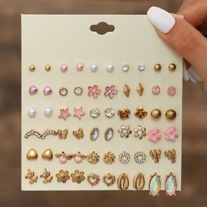 Close-up of 30 pairs earring set featuring gold-tone heart and flower studs on a card