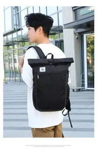 Close-up of waterproof black roll-top backpack with durable buckle and side pocket