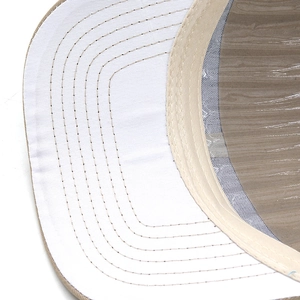 Detailed close-up of white and khaki baseball cap brim with durable stitching