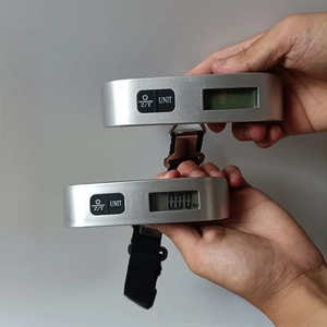 Close-up of portable 50kg digital luggage scale showing on/off status and strap hook