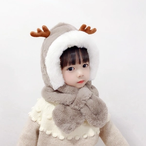 Detail of plush baby hooded scarf with cute brown reindeer antlers in warm coffee and white