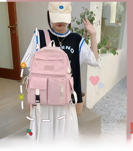 Pink casual nylon backpack for students featuring multiple pockets and white straps