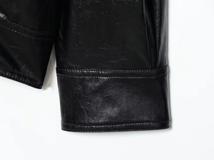 Detailed close-up showing stitching and texture on black PU leather jacket cuffs