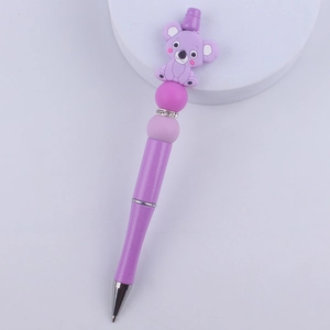 Macro shot of purple glitter DIY beaded pen featuring a cute silicone koala topper
