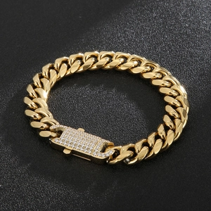 Detailed macro view of iced-out gold Cuban link bracelet with diamond box clasp
