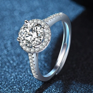 Macro view of a 1-carat brilliant round halo ring with a pavé-set silver band.