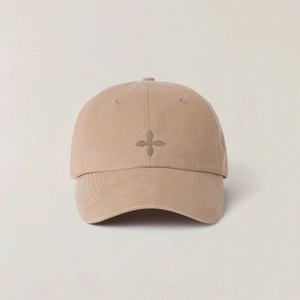 Detailed embroidery of a cross badge on a vintage khaki cotton twill baseball cap
