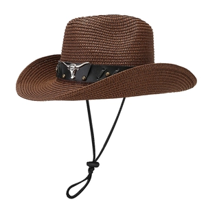 Brown straw cowboy hat with black leather band, metal bull head emblem and chin strap