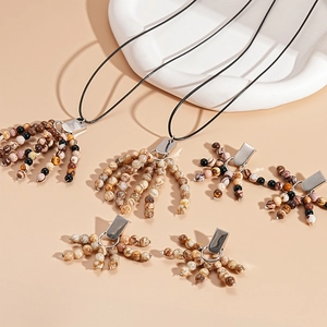Vintage natural stone beaded necklace and earrings set on a decorative white tray