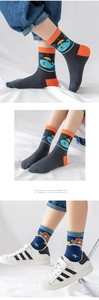 Detail of knit cotton mid-calf socks featuring cute whale and brown bear patterns