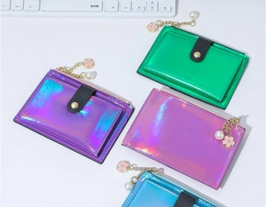 Detail of four holographic PU card holders with gold chains and floral pearl charms