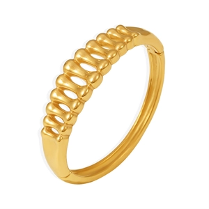Polished gold-plated stainless steel fishbone hollow cuff bracelet on white background