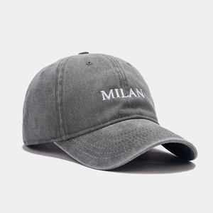 Deep grey washed cotton baseball cap featuring white MILAN embroidery in a side-profile view
