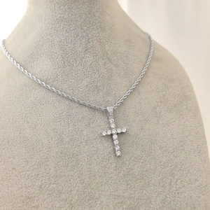 Detailed view of hip hop cross pendant with clear rhinestones on silver rope chain