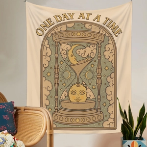 Detail of vintage hourglass tapestry with sun and moon art in a cozy boho room setup