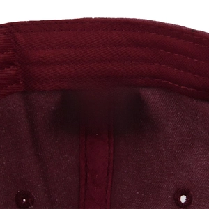 Detail view of cotton baseball cap interior showing 100% cotton label and twill fabric