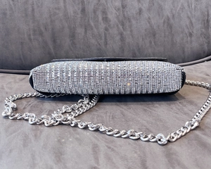 Detailed view of silver rhinestone mini bag showing sparkling crystal bottom and chain
