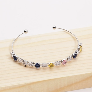 Detail view of silver cuff bangle featuring colorful marquise and square cut zircons