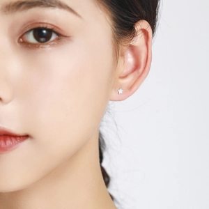 Minimalist S925 sterling silver star stud earring worn on model for a refined look
