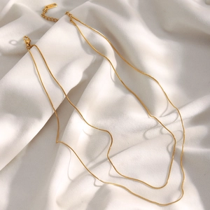 Detail of 18K gold-plated double-layer snake chain necklace with lobster clasp