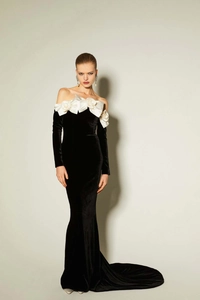 Detail of off-shoulder black velvet evening gown with 3D white rose floral neckline
