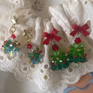 Handmade beaded Christmas tree earrings with red bows and colorful crystal stars