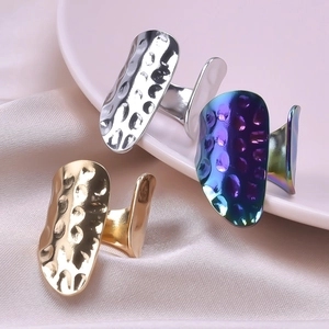 Detail of hammered texture open rings in gold, silver and iridescent finishes on satin