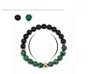 Detail of 8mm malachite and matte black stone beaded bracelet with size measurements
