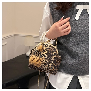 Close-up of leopard print handbag with gold metal ring handle and chain strap