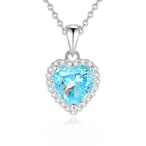Close-up of heart-shaped blue gemstone pendant in S925 sterling silver with halo diamonds