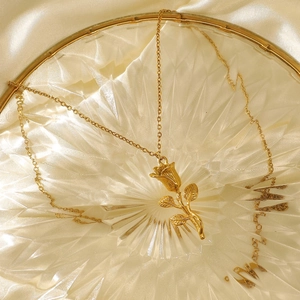 Elegant 18K gold plated 3D rose flower pendant necklace for women on silk background