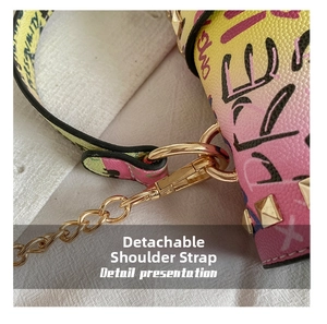 Detail presentation of detachable strap with gold hardware on graffiti jelly bag