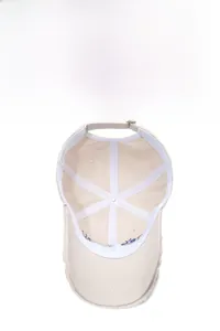 Detail of off-white baseball cap interior with white sweatband and blue embroidery
