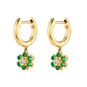 Close-up of snowflake earrings featuring gold base with green and white zircon stones