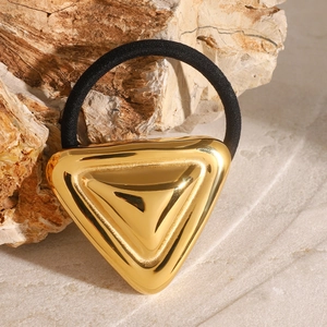 Geometric stainless steel hair tie featuring a polished gold triangle on a black elastic band