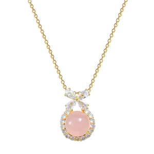 Elegant gold bow necklace with pink round gemstone and clear crystal accents on white