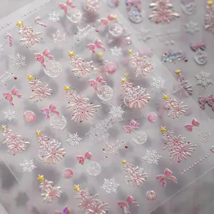 Macro detail of 5D embossed shell luster nail stickers with Christmas tree and snowflake