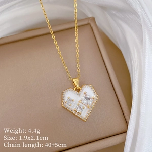 Detail of gold titanium steel heart necklace with white enamel, zircon, and product dimensions