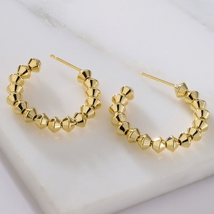 Chic gold-plated C-shaped earrings with beaded stud texture on marble surface